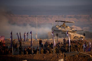 Israeli soldiers drive a tank along the Israeli-Gaza border on Friday